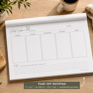 May include: A white paper tear-off notepad with a cardboard backing, measuring 11 inches by 8.5 inches. The notepad features a weekly meal planner layout with columns for Monday through Friday, a section for notes, and the text Whats Cookin.