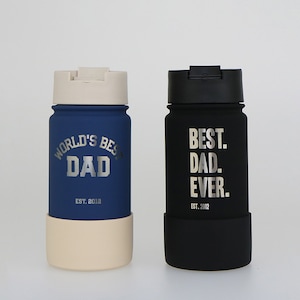May include: Two stainless steel water bottles with a black lid and a silicone bottom. The blue bottle has the text "WORLD'S BEST DAD EST. 2012" and the black bottle has the text "BEST. DAD. EVER. EST. 2012".