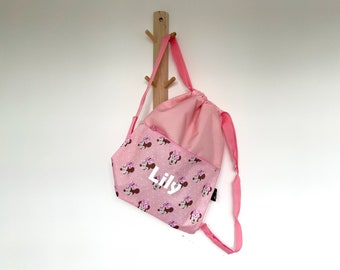 May include: Pink drawstring backpack with a Minnie Mouse print and the name "Lily" in white lettering.
