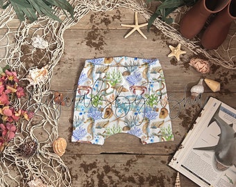 Realistic Harem shorts mockup for photoshop/ procreate or similar. children's clothing mock-up, kids shorts mock up, beach theme background