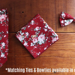 May include: A set of three matching accessories in a red floral pattern. The set includes a tie, a bow tie, and a pocket square.