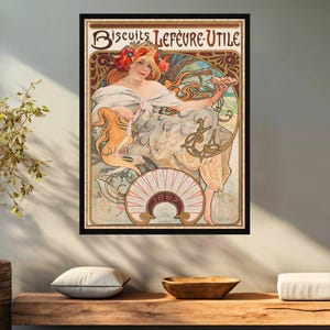 May include: A vintage poster advertising "Biscuits Lefèvre-Utile" featuring an Art Nouveau illustration of a woman holding a plate of biscuits. The poster is framed in black and has a gold border. The text "Biscuits Lefèvre-Utile" is in a decorative font and the year "1892" is also included.