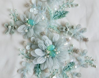 Hand-made motif of organza and velvet flowers in a delicate shade of surf green