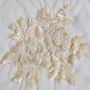 Hand-embroidered applique with ivory-sand raffia flowers