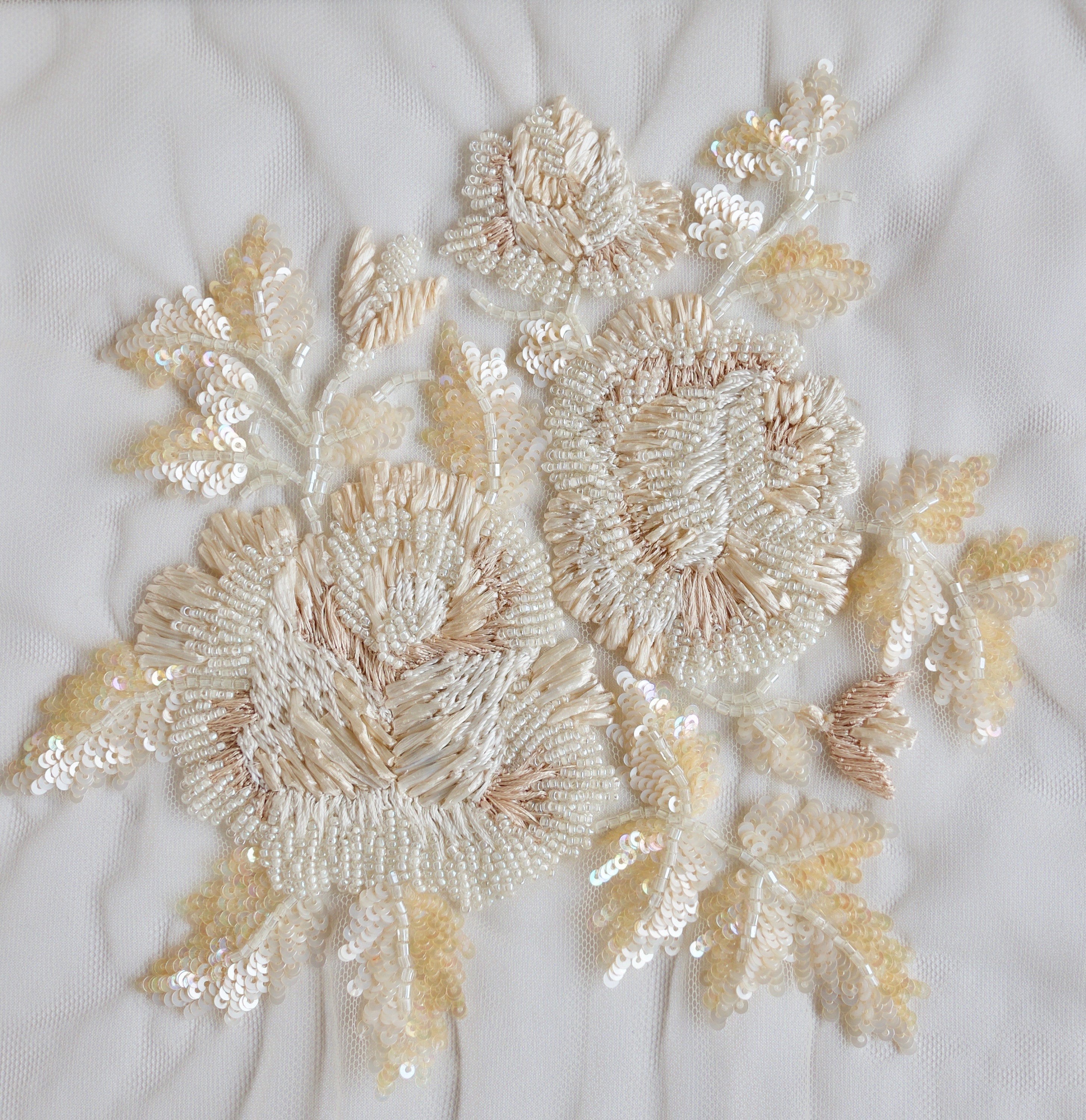 Hand-embroidered applique with ivory-sand raffia flowers