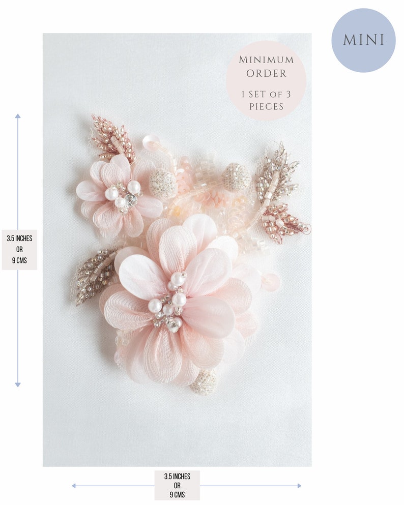 May include: A set of three delicate pink flower embellishments with pearl and rhinestone accents. Each flower measures 3.5 inches or 9 cm in diameter. The embellishments are perfect for adding a touch of elegance to clothing, accessories, or home decor.