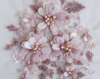 Hand-made motif with pearls, twinkling balls of glass beads and petals wrapped in organza