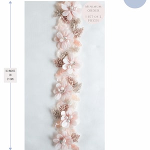 May include: A delicate pink and gold floral trim with a minimum order of 1 set of 2 pieces. The trim is 8.3 inches or 21 cm long and 1.6 inches or 4 cm wide.