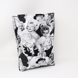 May include: Black and white tote bag with a collage of Marilyn Monroe images.