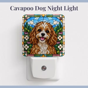 May include: A square night light featuring a stained glass style illustration of a brown and white Cavapoo dog surrounded by flowers and greenery. The text Cavapoo Dog Night Light is printed above the light, which has a white plastic base.