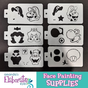 May include: A set of face painting stencils featuring iconic characters. The stencils include Mario, Princess Peach, Yoshi, and other recognizable designs. The text "Face Painting Supplies" is visible at the bottom.