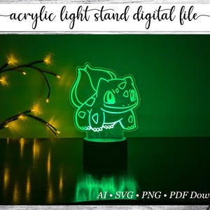 May include: A green acrylic light stand featuring a Bulbasaur design, illuminated against a green backdrop. The text "acrylic light stand digital file" is at the top. The bottom includes file type information.