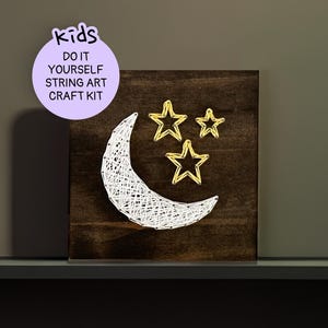 May include: A DIY string art craft kit for kids featuring a crescent moon and stars. The kit includes everything needed to create a fun and easy string art project.