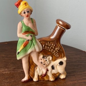 Ceramic , Porcelain flask/bottle , 1920&#39;s , a woman dressed as a flapper holding an umbrella