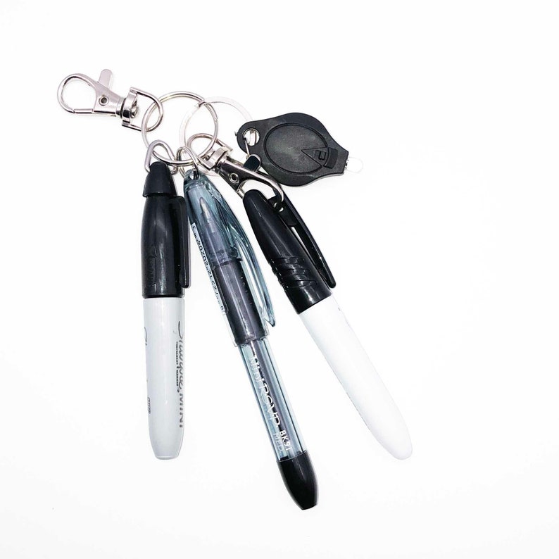 Sharpie badge reel accessories add on in black with pen, sharpie, dry erase marker, and LED keychain mini light.