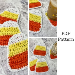 May include: A collection of handmade crochet coasters in the shape of candy corn. Each coaster features orange, yellow, and white stripes, with a white border. The image includes a glass of iced coffee resting on one of the coasters. The text "PDF Pattern" is visible.