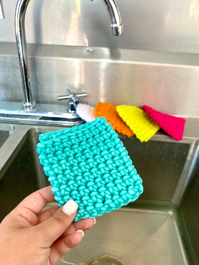 May include: A set of five knitted dishcloths in various colors, including turquoise, yellow, orange, pink, and white. The cloths are made of a soft, absorbent material and are perfect for cleaning dishes and countertops.