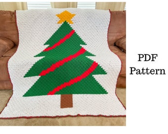 May include: A white crochet blanket with a green and red Christmas tree design. The tree has a brown trunk and a yellow star on top. The blanket is on a brown couch. PDF Pattern.