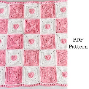 May include: A crochet baby blanket with a pink and white checkerboard pattern and pink heart accents. PDF Pattern.