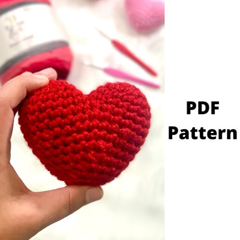 May include: A red crocheted heart-shaped amigurumi pattern. The pattern is available as a PDF download.
