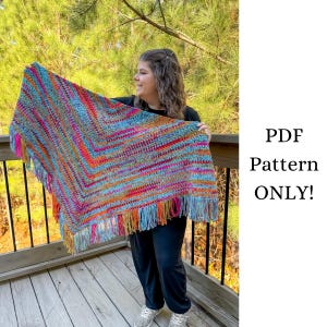 May include: A colorful crochet shawl with a fringe border. The shawl is held by a person wearing black pants and shoes. The text "PDF Pattern ONLY!" is visible in the image.