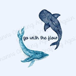 May include: A watercolor illustration of two whales swimming in opposite directions. The whale on the left is blue and the whale on the right is dark blue. The text "go with the flow" is written in black cursive lettering between the whales.