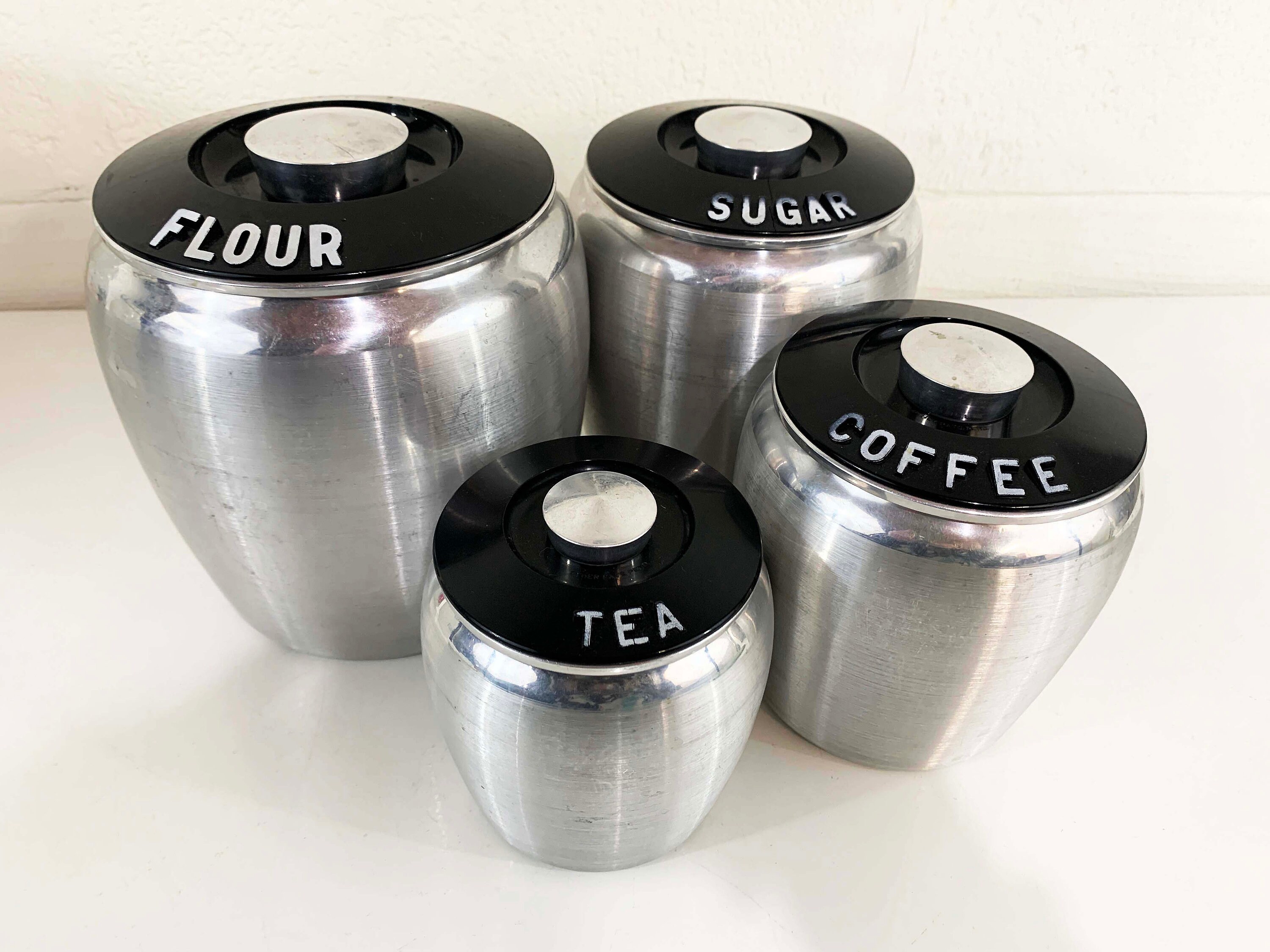 5 piece stackable Kromex silver canisters with black label and handle in excellent condition