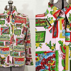 May include: A vintage button-down shirt with a light pink background and a colorful, repeating pattern. The pattern includes framed images with red, green, yellow, and blue elements. The shirt has a pointed collar and long sleeves, displayed on a mannequin.