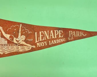 May include: A vintage pennant with a red background and white lettering. The pennant features a drawing of a person diving into water and the text "LENAPE PARK MAYS LANDING, N.J."