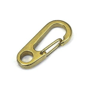 May include: A gold-colored metal carabiner clip with a spring-loaded gate.