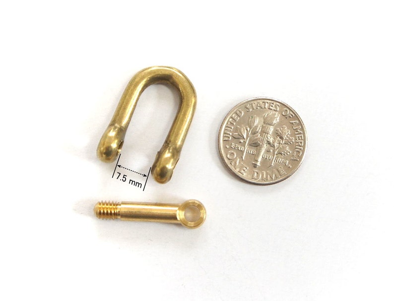 May include: A brass swivel snap hook with a threaded eyelet. The hook is 7.5 mm wide and is shown next to a US dime for scale.