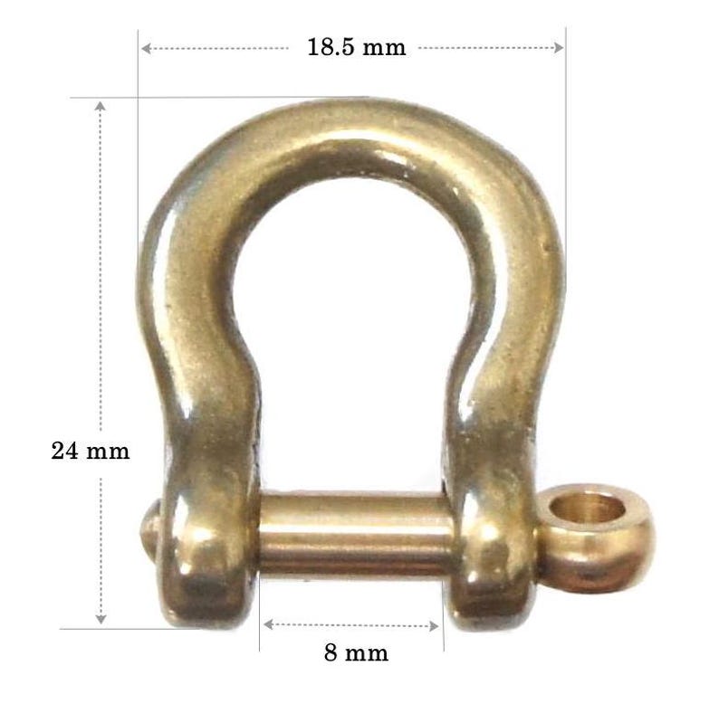 May include: A gold-colored metal D-ring with a diameter of 18.5 mm, a height of 24 mm, and a width of 8 mm.