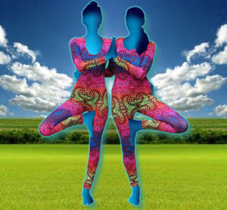May include: Two people wearing colorful, patterned leggings are doing yoga poses in a field. The leggings have a psychedelic, abstract design with pink, blue, green, and yellow colors.