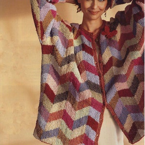 May include: A colorful cardigan with a chevron pattern in shades of pink, purple, brown, and green. The cardigan has a button closure and is made of a soft, knitted fabric.