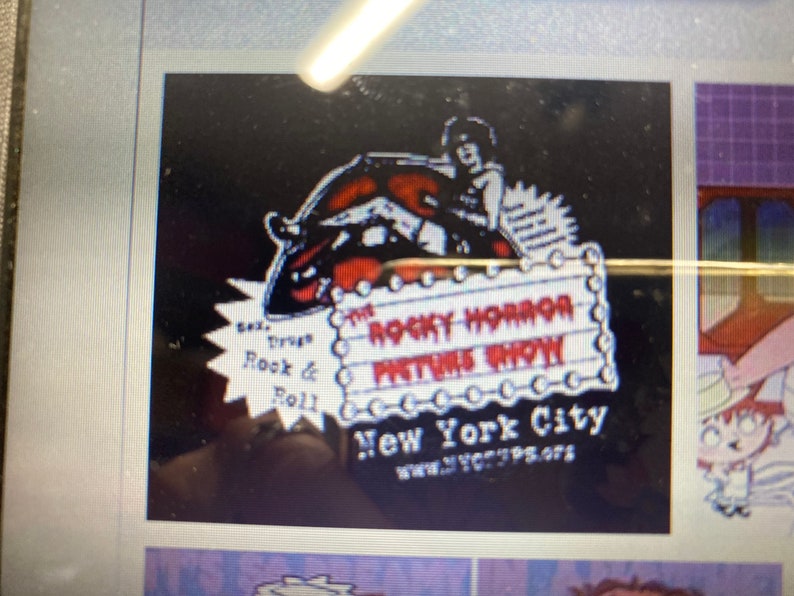 May include: A black and red graphic for "The Rocky Horror Picture Show" with a stylized image of a person and text. The text includes "Sex, Drugs, Rock & Roll" and "New York City". The website www.nycRPS.org is also visible.