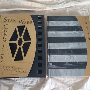 May include: A gold and black hardcover book titled "Star Wars Chronicles" by Deborah Fine and Aeon Inc. The cover features a black and gold illustration of a Star Wars symbol.
