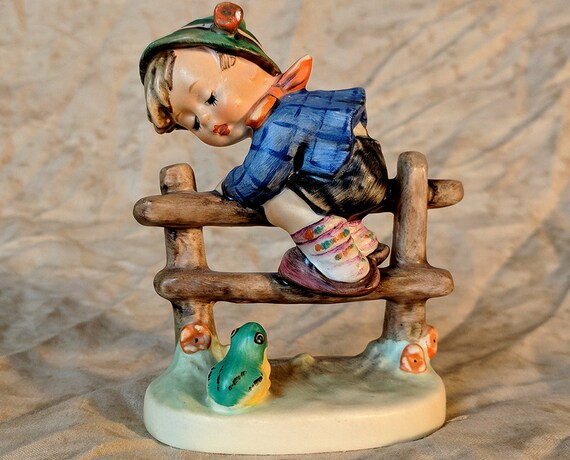 hummel boy on fence with frog