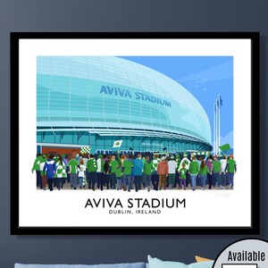 May include: Illustration of the Aviva Stadium in Dublin, Ireland, with a crowd of people in green and white. The stadium has a curved, glass-like roof. The text "AVIVA STADIUM" is visible on the building. The image is framed in black.