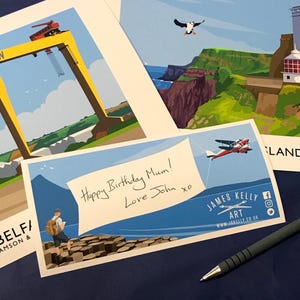 A birthday card with a handwritten message and an illustration of a person standing on a rocky cliff overlooking a body of water, with a bird flying overhead.