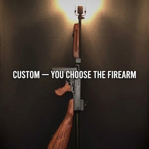 May include: A lamp constructed from a firearm with a wooden stock, grip, and handguard. The light fixture is mounted at the top of the barrel. The text CUSTOM — YOU CHOOSE THE FIREARM is displayed across the center of the image in white letters.