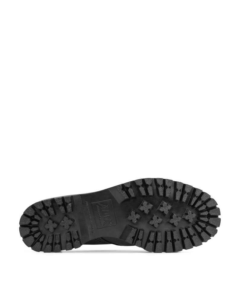 May include: Black boot sole with a deep tread pattern. The sole features cross-shaped designs and the brand name is visible. The boot sole is made of a durable material.