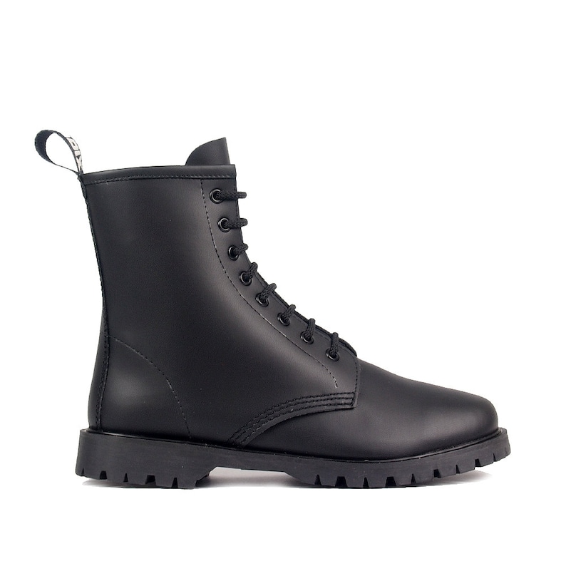 May include: A black leather boot with a lace-up design and a thick, lug sole. The boot has a pull tab at the back and a rounded toe. The boot is approximately 8 inches tall.