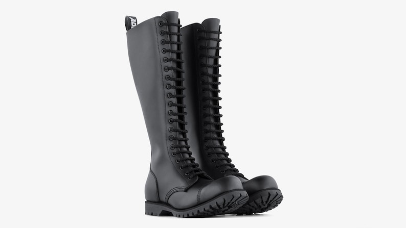 May include: Pair of black knee-high boots with a lace-up design. The boots have a rounded toe, a thick sole, and a pull tab at the top. The boots are made of a smooth, matte material.