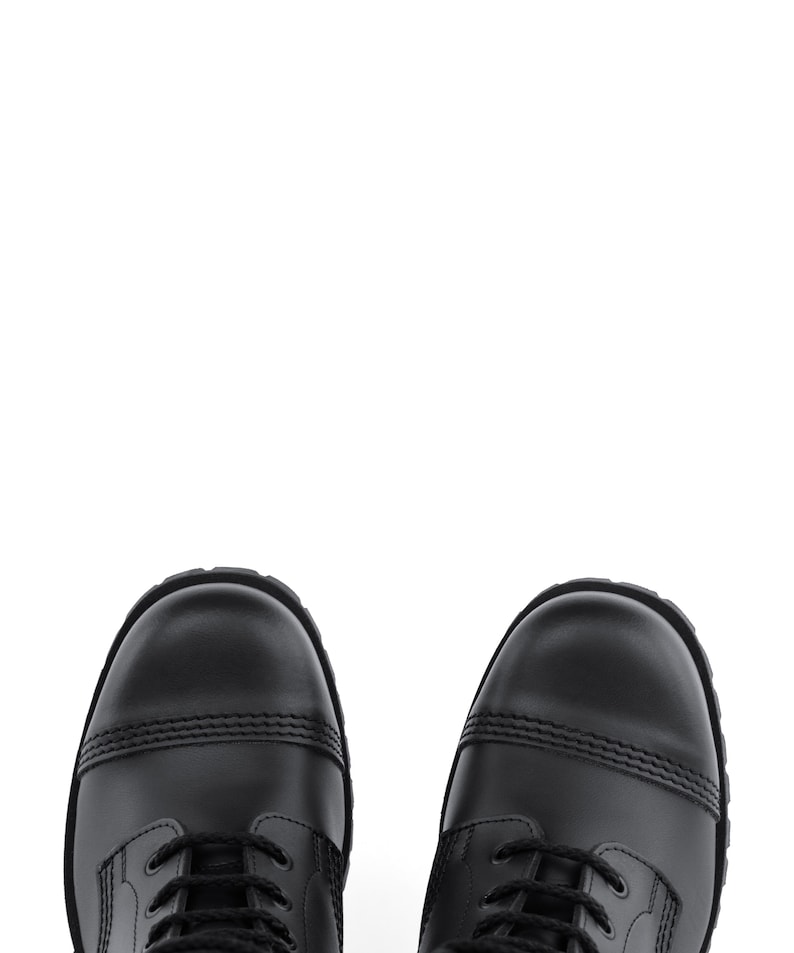 May include: A pair of black leather boots with a cap toe design. The boots have black laces and a sturdy sole. The image is a top-down view of the boots against a white background.