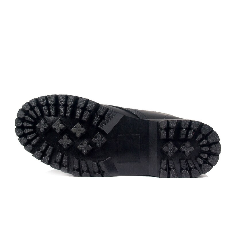 May include: Black boot sole with a rugged, textured tread pattern. The sole is made of a durable material and features a series of deep grooves and geometric shapes for traction. The boot sole is designed for outdoor use.