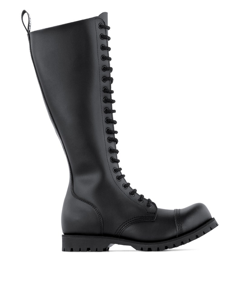 May include: A knee-high black leather boot with a lace-up front and a chunky sole. The boot has a rounded toe and a pull loop at the top. The boot measures approximately 40 cm in height.