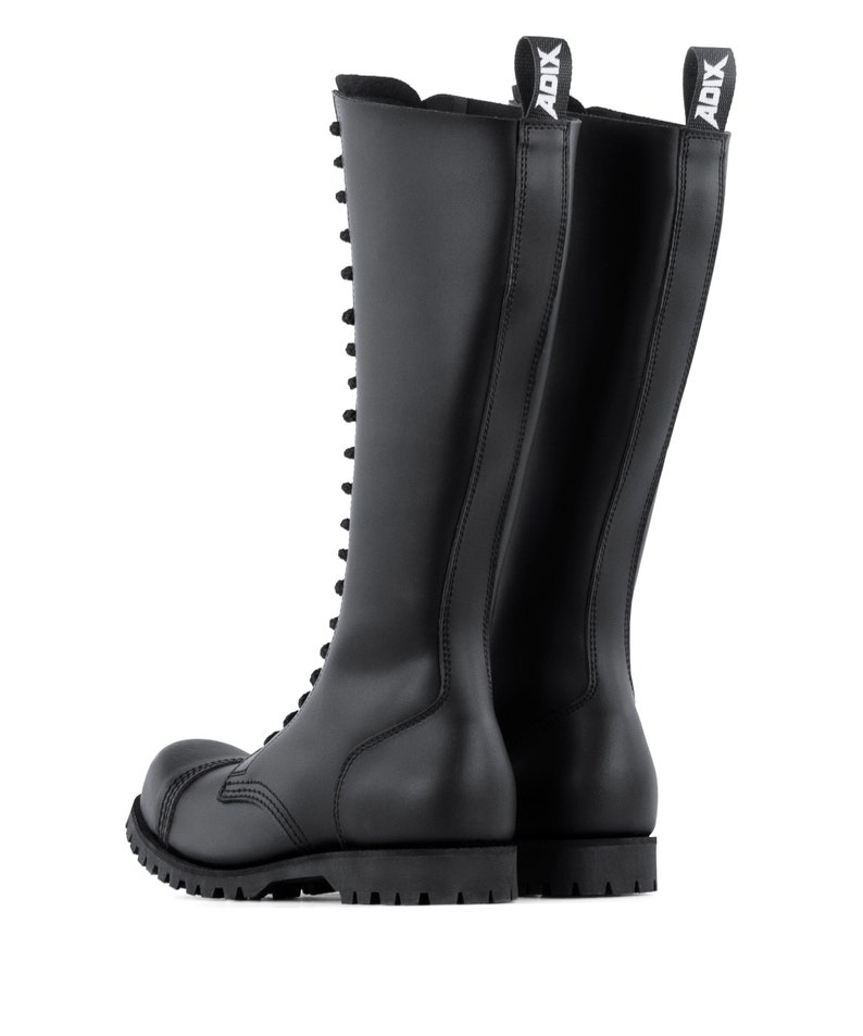 May include: Black leather knee-high boots with a lace-up design and a thick, lug sole. The boots have a rounded toe and a pull tab at the top with the brand name "ADIX" in white. These boots are designed for durability and style.