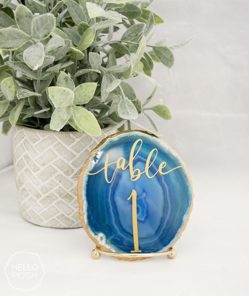 May include: Blue agate table number holder with gold foil lettering that says "table 1".