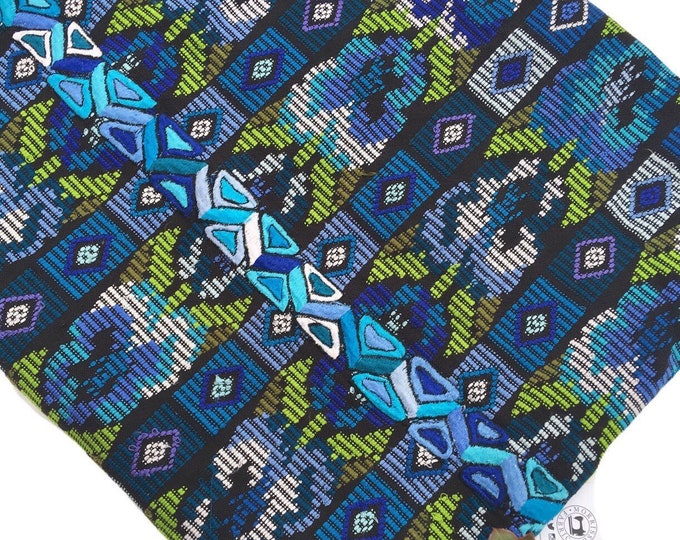 vintage Guatemalan fabric in blue, green, and black geometric floral design. Turquoise embroidery center