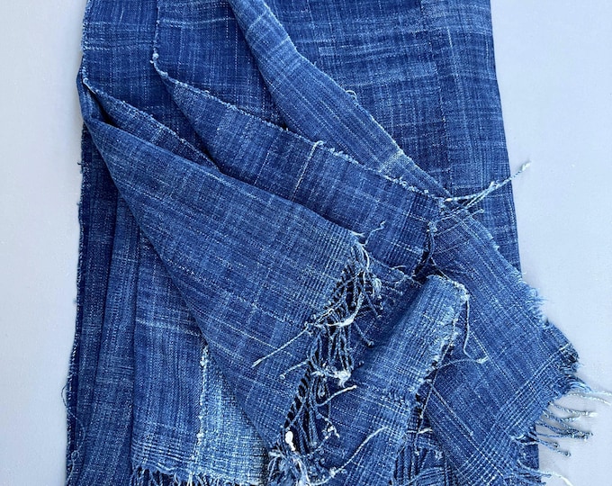 Vintage throw blanket made of blue mud cloth. Distressed jeans textile with fringe for pillows or bedding